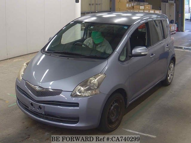 A grey JDM sports car speeding down a highway at night.