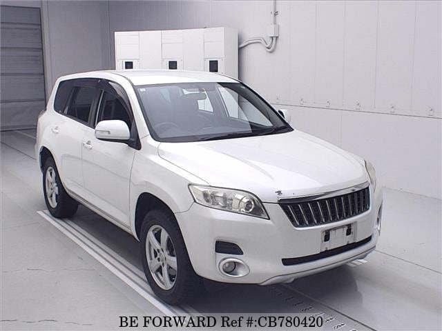 A grey JDM sports car speeding down a highway at night.