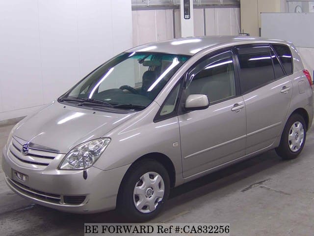 A grey JDM sports car speeding down a highway at night.