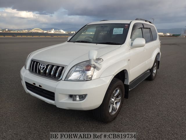 A grey JDM sports car speeding down a highway at night.