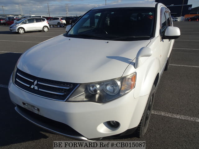 A grey JDM sports car speeding down a highway at night.