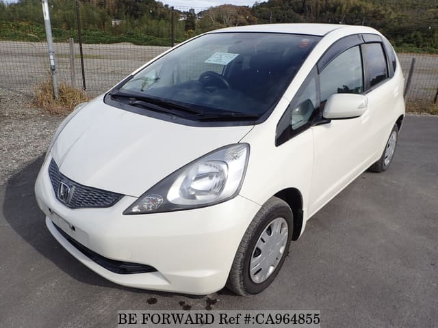 A grey JDM sports car speeding down a highway at night.
