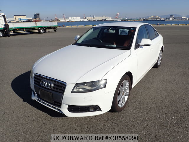 A grey JDM sports car speeding down a highway at night.