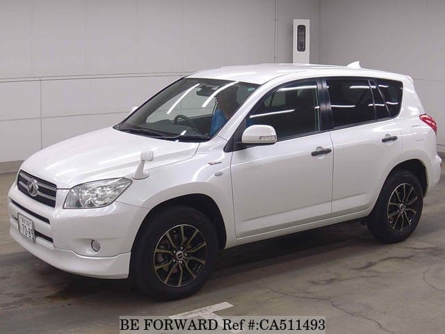 A grey JDM sports car speeding down a highway at night.