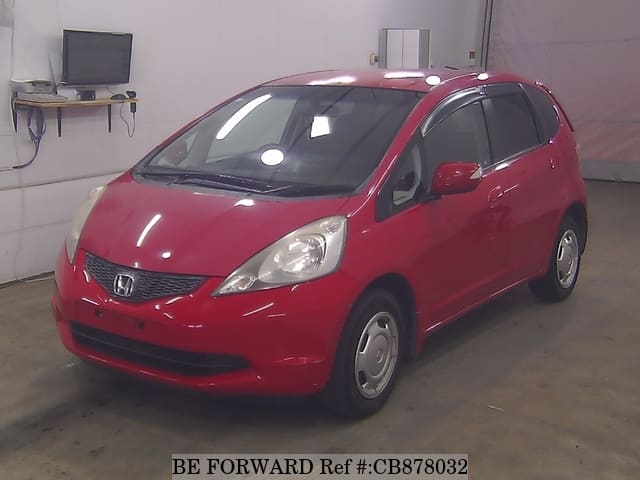 A grey JDM sports car speeding down a highway at night.