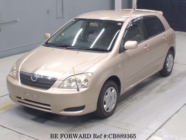 A grey JDM sports car speeding down a highway at night.