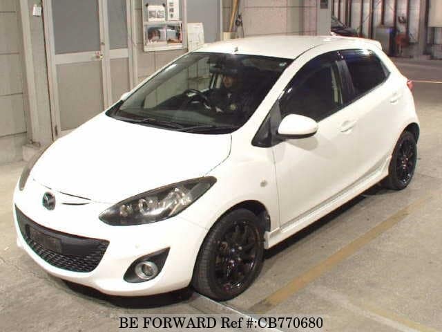 A grey JDM sports car speeding down a highway at night.