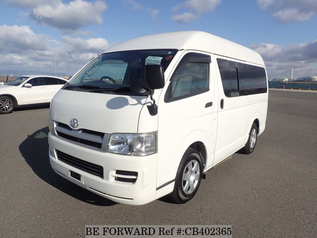 A grey JDM sports car speeding down a highway at night.