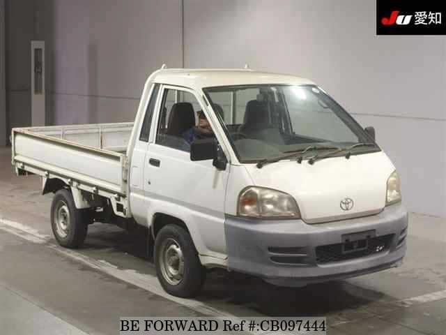 A grey JDM sports car speeding down a highway at night.