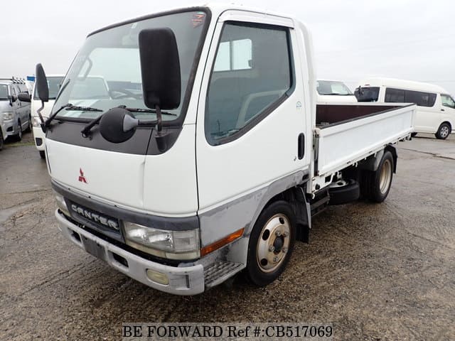 A grey JDM sports car speeding down a highway at night.
