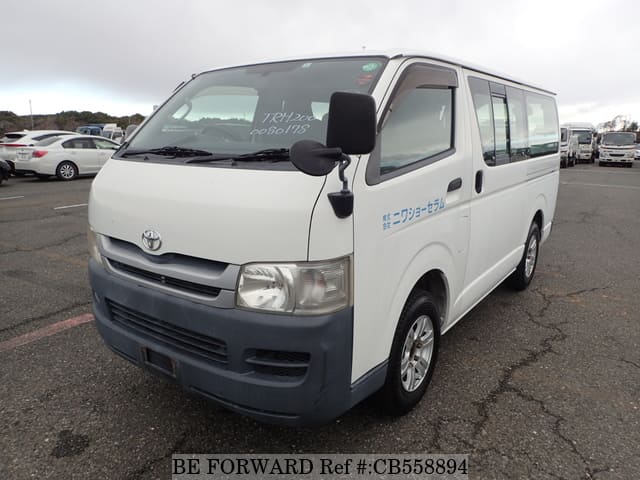 A grey JDM sports car speeding down a highway at night.