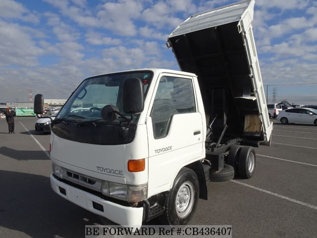 A grey JDM sports car speeding down a highway at night.