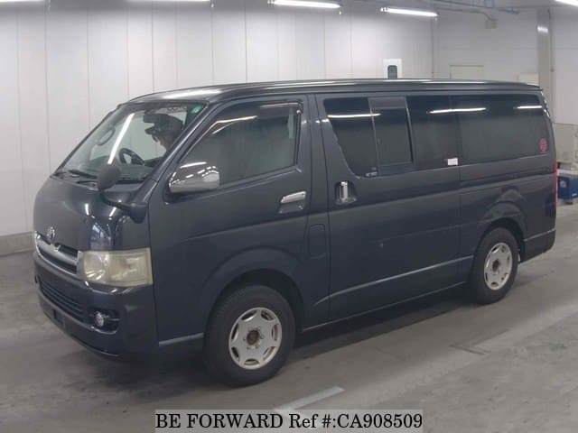 A grey JDM sports car speeding down a highway at night.