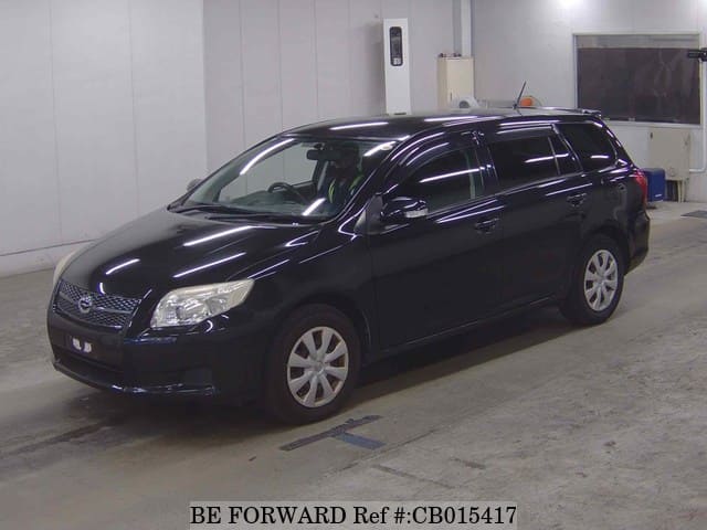 A grey JDM sports car speeding down a highway at night.