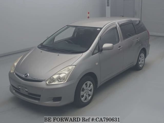 A grey JDM sports car speeding down a highway at night.