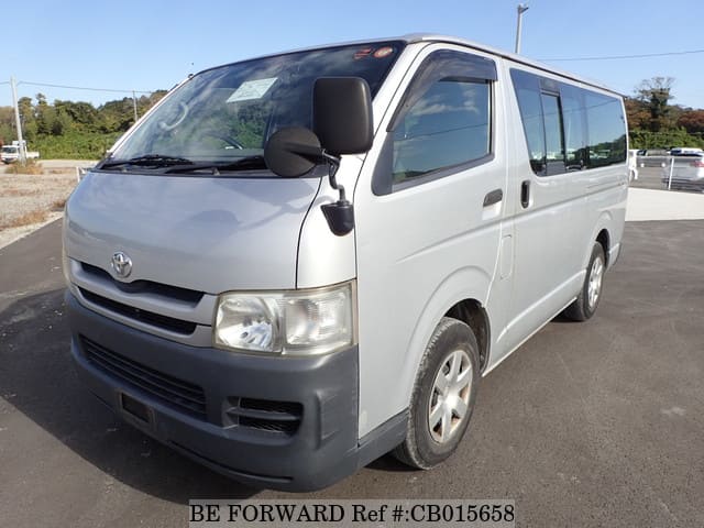A grey JDM sports car speeding down a highway at night.
