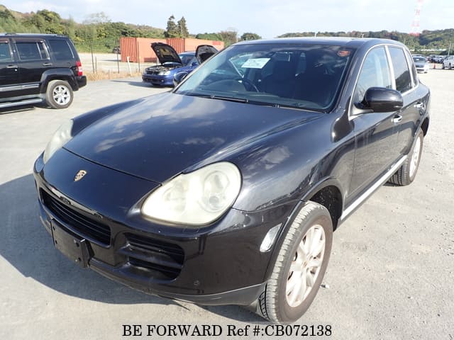 A grey JDM sports car speeding down a highway at night.