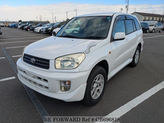 A grey JDM sports car speeding down a highway at night.
