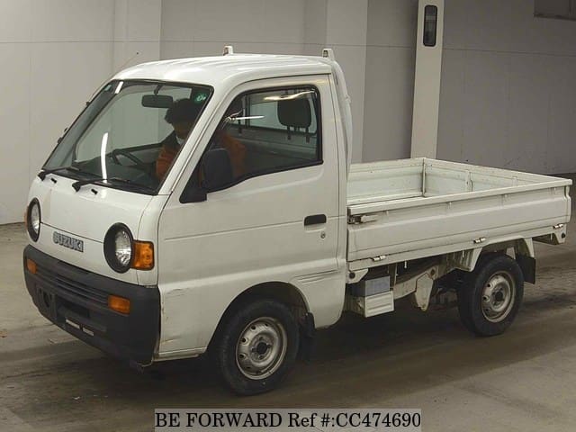 A grey JDM sports car speeding down a highway at night.