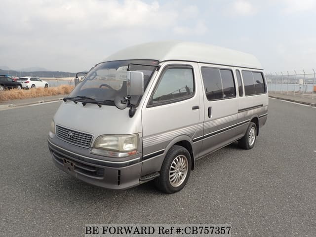 A grey JDM sports car speeding down a highway at night.
