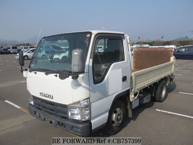 A grey JDM sports car speeding down a highway at night.
