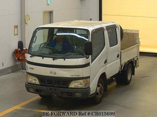 A grey JDM sports car speeding down a highway at night.