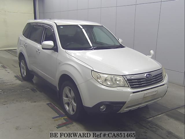 A grey JDM sports car speeding down a highway at night.