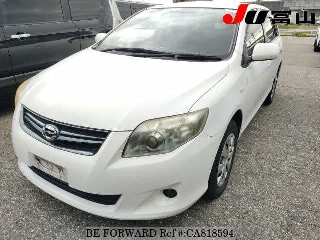 A grey JDM sports car speeding down a highway at night.