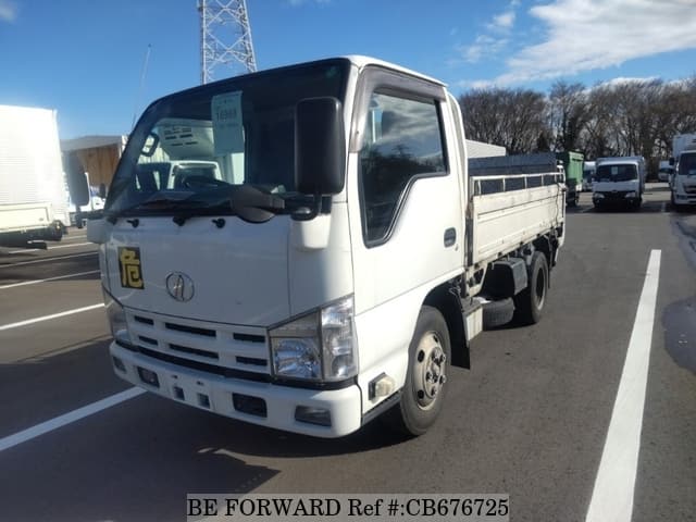 A grey JDM sports car speeding down a highway at night.