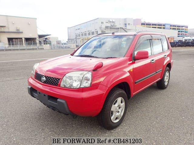 A grey JDM sports car speeding down a highway at night.
