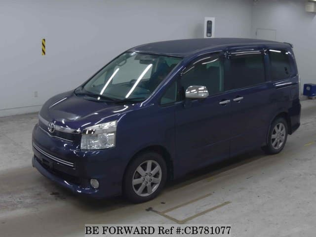 A grey JDM sports car speeding down a highway at night.