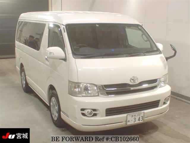 A grey JDM sports car speeding down a highway at night.