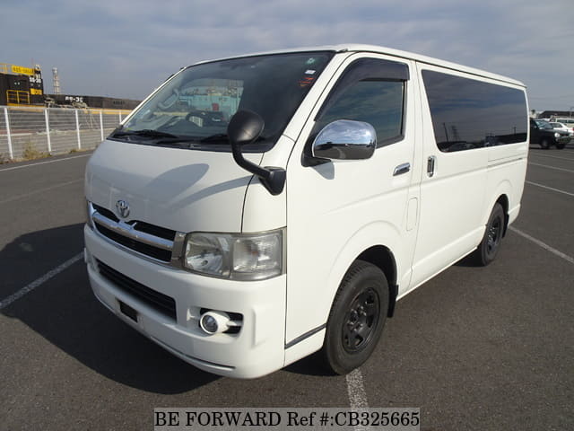 A grey JDM sports car speeding down a highway at night.