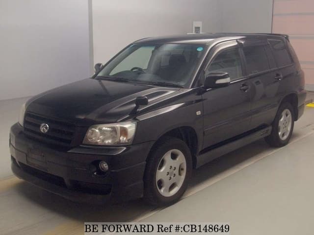 A grey JDM sports car speeding down a highway at night.