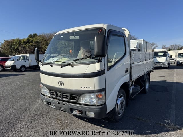 A grey JDM sports car speeding down a highway at night.