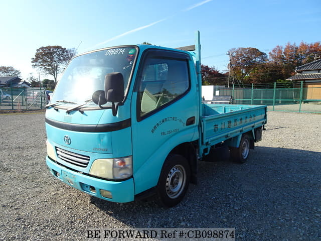 A grey JDM sports car speeding down a highway at night.