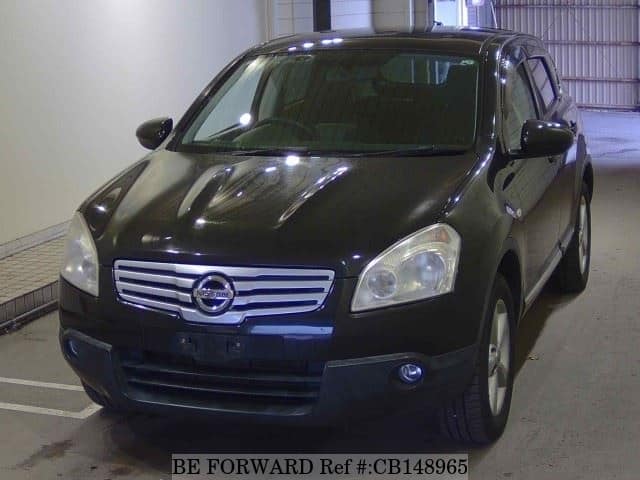 A grey JDM sports car speeding down a highway at night.