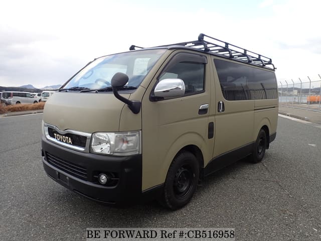 A grey JDM sports car speeding down a highway at night.