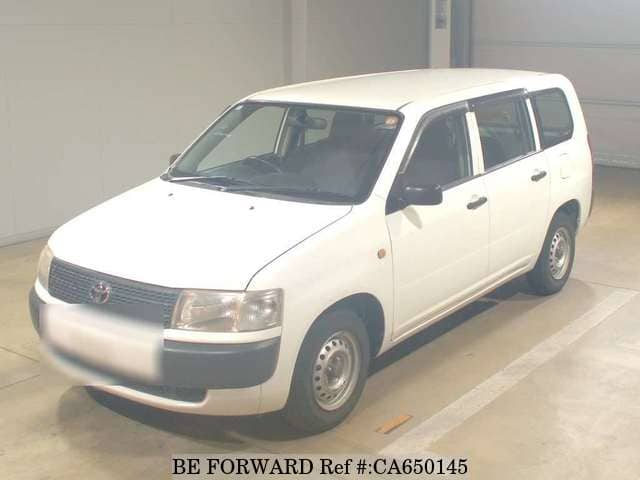 A grey JDM sports car speeding down a highway at night.