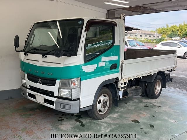 A grey JDM sports car speeding down a highway at night.
