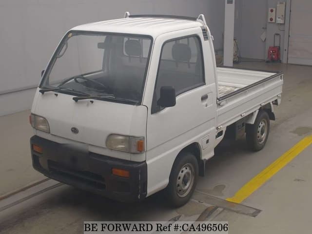 A grey JDM sports car speeding down a highway at night.