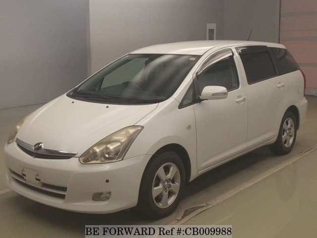 A grey JDM sports car speeding down a highway at night.