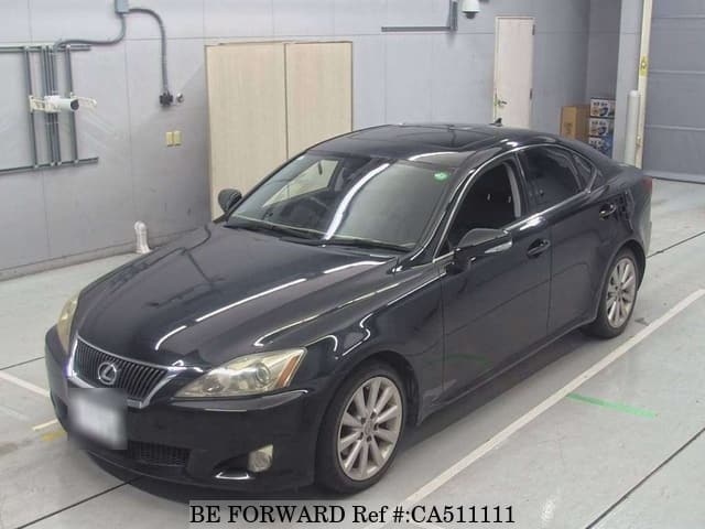 A grey JDM sports car speeding down a highway at night.