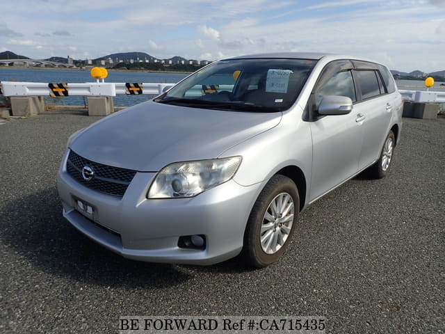 A grey JDM sports car speeding down a highway at night.