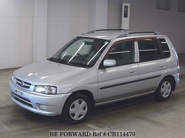 A grey JDM sports car speeding down a highway at night.