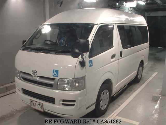 A grey JDM sports car speeding down a highway at night.