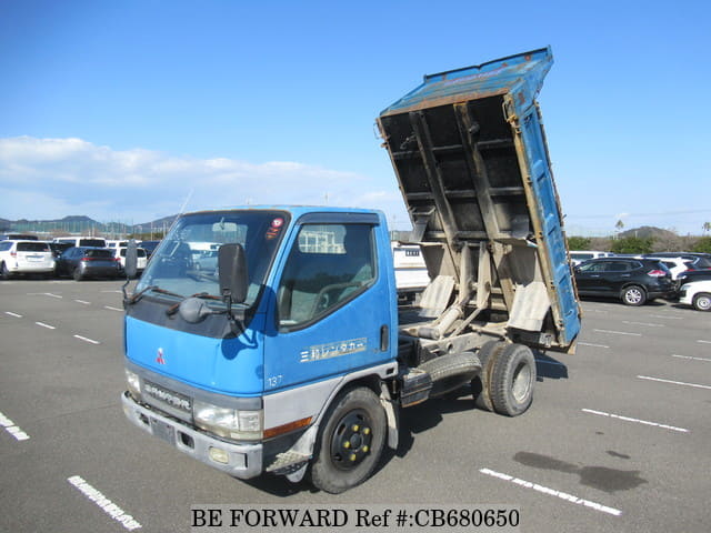A grey JDM sports car speeding down a highway at night.