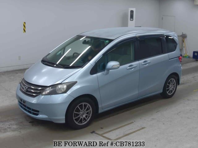 A grey JDM sports car speeding down a highway at night.