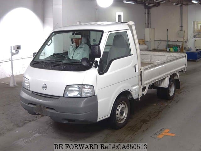 A grey JDM sports car speeding down a highway at night.