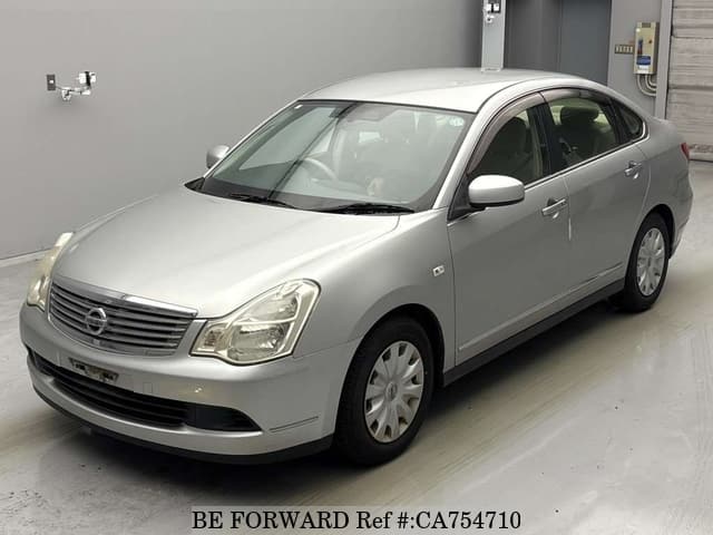 A grey JDM sports car speeding down a highway at night.